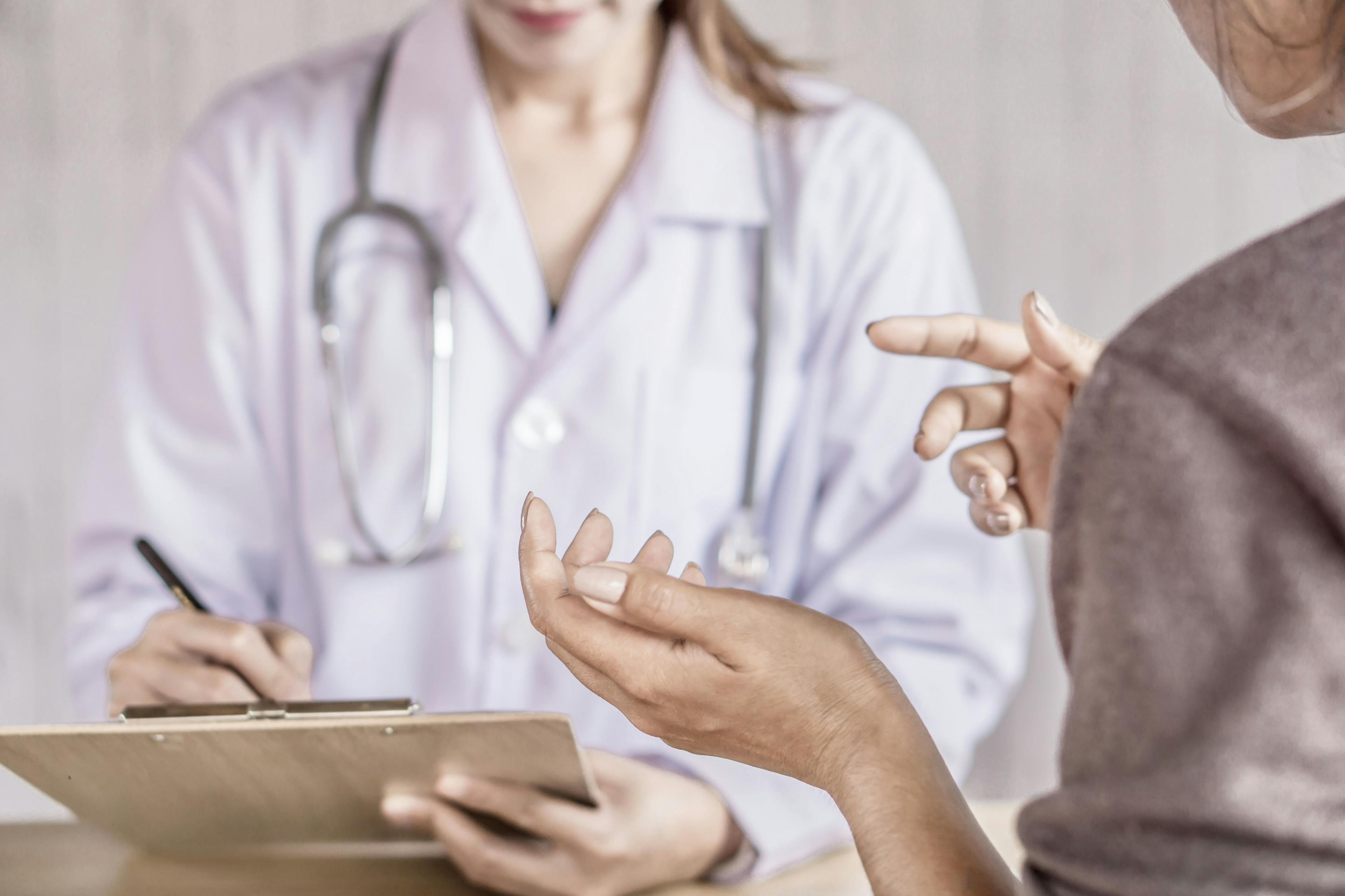 Image of a patient talking with their doctor.