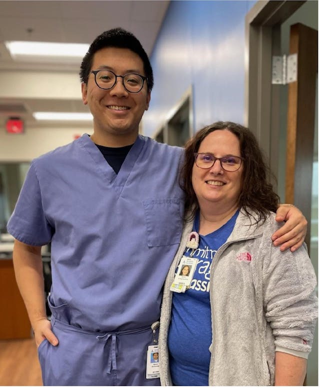  From left: Marcus Yoakam, B.S.N., RN, ONS with his arm around Kristen Mitchell, A.D.N.. Both are standing in a hospital hallway, smiling at the camera. |  Photo provided by Marcus Yoakam, B.S.N., RN, ONS